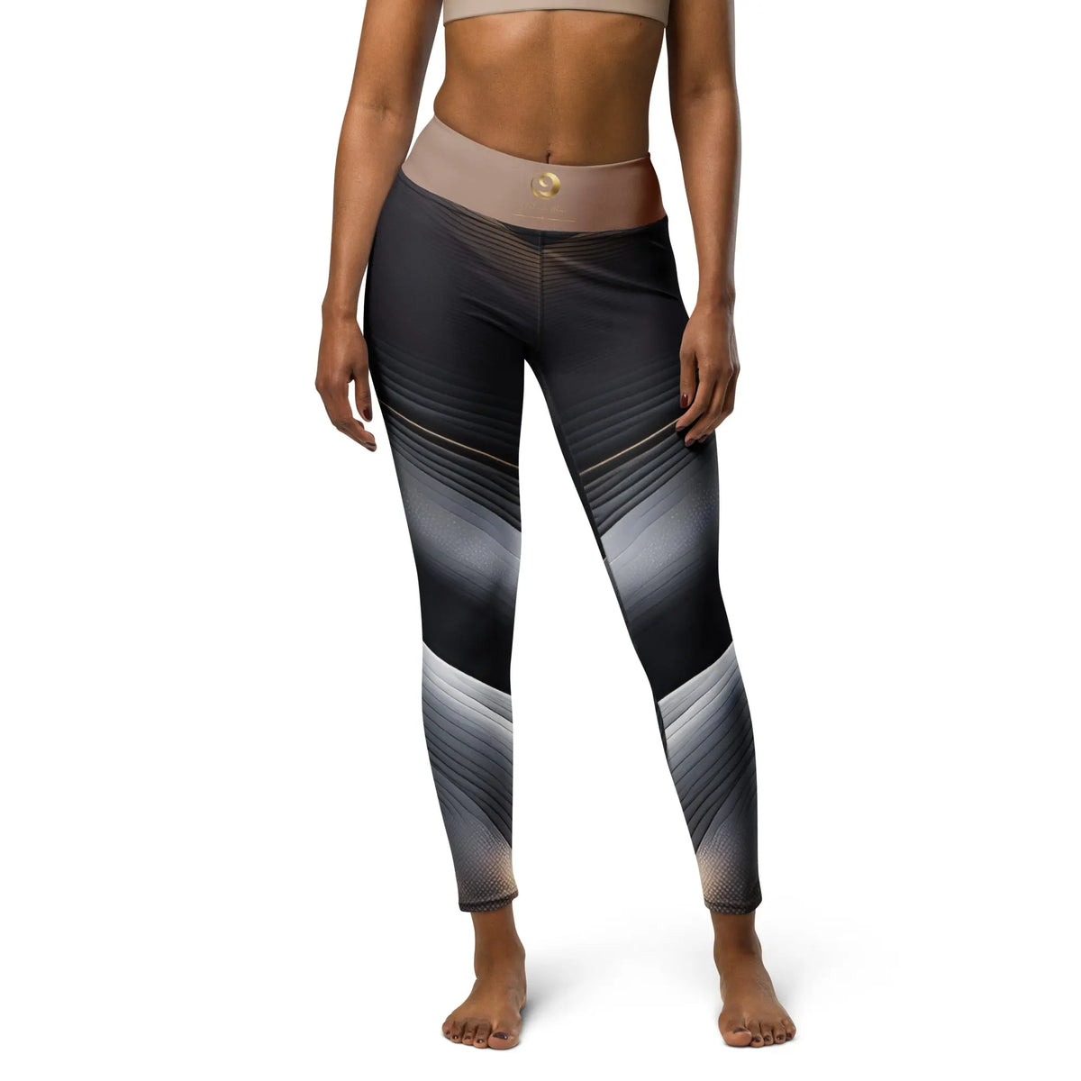 A pair of black and tan yoga leggings with a raised waistband and geometric patterns on the sides.