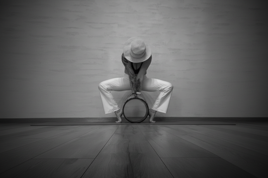Kamala in a deep forward fold with a yoga wheel — Eternal Agape Community Spotlight